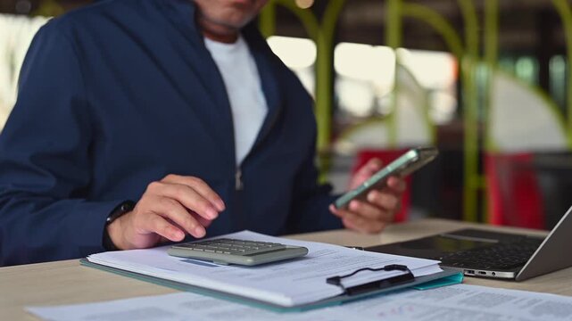 Accountant conducts accounting review, executing accounting tasks, organizing accounting documents, analyzing corporate finance, tracking personal finance, holding calculator.