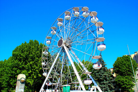LECCO, ITALY - MAY 30, 2025: Ferris Wheel. Located on the Riva Martiri delle Foibe along the Lago di Como waterfront, offers scenic views of the city and surrounding mountains, featuring 18 cabins