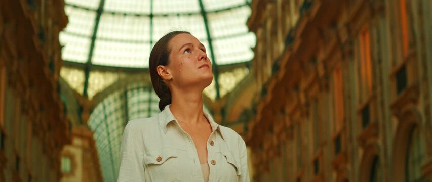 Woman admiring the dome inside Galleria Vittorio Emanuele II in Milan Italy