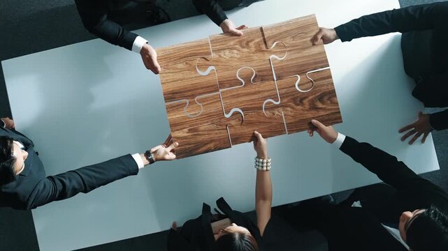 Top view of skilled businesspeople hand bring and fill the last jigsaw piece together. Group of project manager complete puzzle or solving problem. Unity, teamwork, successful project. Directorate.