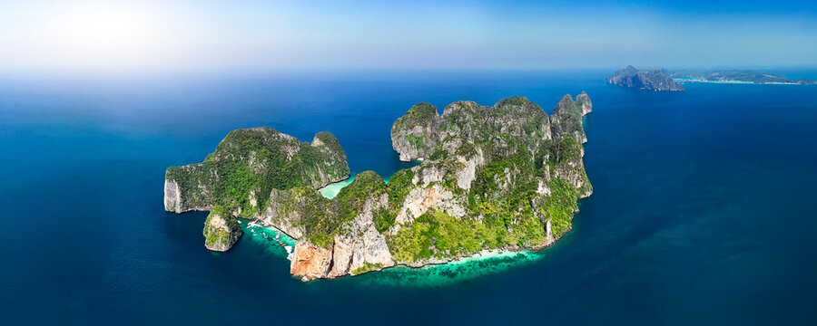 Amazing rock island in the sea with beautiful nature around coral reefs and popular famous tourist place all over the world, panoramic aerial view from above