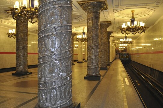 Elegant platform with incoming train, decorated columns and chandeliers, metro, Saint Petersburg, St. Petersburg, Russia