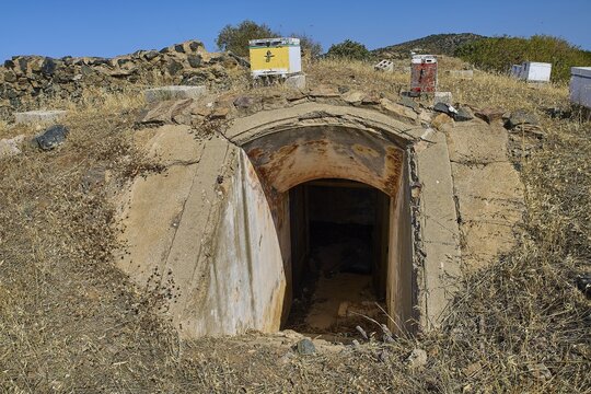 Lost Place, concrete bunker entrance in dry landscape under blue sky with vegetation, Italian air defence position, ground defence position, PL306 with 6 cannons, WW2, Vigla Mountain, Vigla, above Lakki, Lakki, Leros, Dodecanese, Girechian Islands, Greece