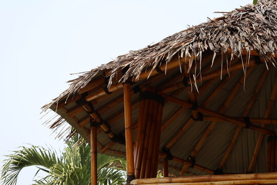 Traditional bamboo foundation building with leaf roof showcasing sustainable tropical architecture and craftsmanship.