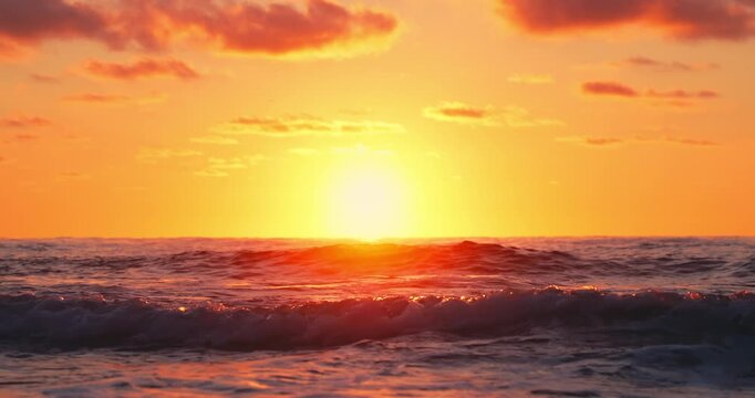 Golden Sunrise Over Calm Ocean Horizon With Reflecting Sunlight And Gentle Waves At Dusk on the shore