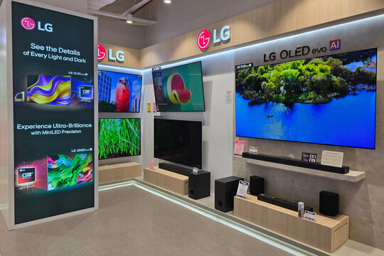 Penang, Malaysia - Jul 27, 2026: LG OLED evo AI smart televisions and home audio soundbars on display in the home appliance department of a Harvey Norman store.   