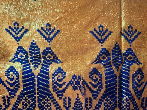 Yellow songket fabric with blue pattern