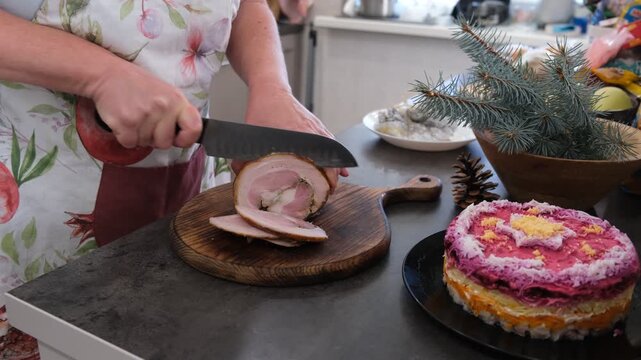 Baked pork belly. The cutting process. Preparing for the holiday. Christmas.