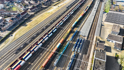 Obraz premium Railroad, train tracks and trains aerial drone view from above, railway station in Venlo, the Netherlands, transportation, logistics and public transport infrastructure 