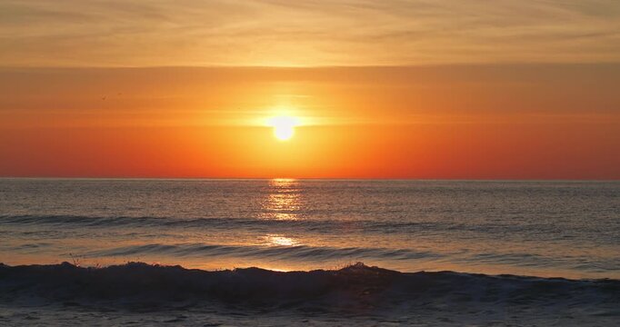 Tropical summer sunrise over the sea waves and beach shore