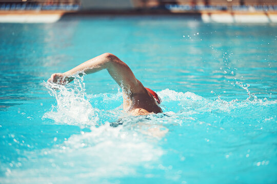 Fitness, person and swimming pool for workout, exercise and aquatic practice for body wellness. Back, swimmer and training for water sports, freestyle technique and healthy lifestyle in summer