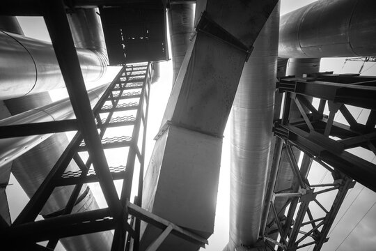 Abstract industrial metal pipes and ventilation ducts monochrome architectural background with copy space