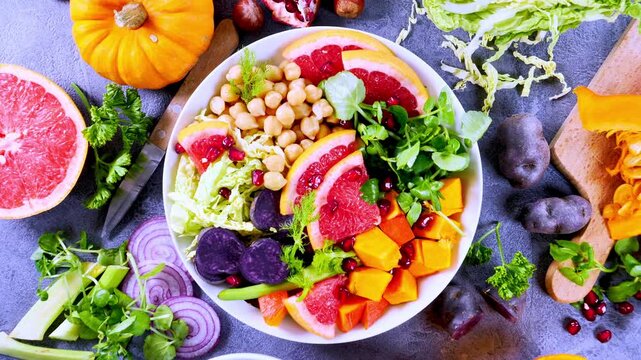 colorful buddha bowl with chickpeas, grapefruit and autumn vegetables