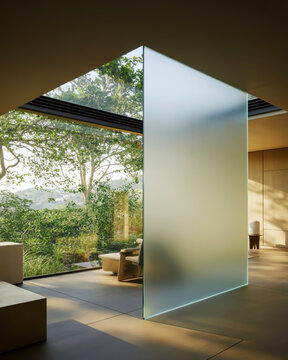 Modern interior with frosted glass partition and lush green outdoor view architecture home