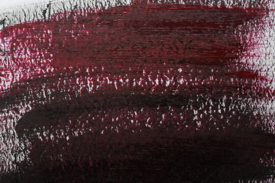 Black and red smudge on a white surface.