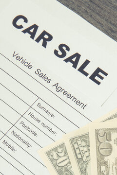 Form of vehicle sales agreement and dollar banknotes. Sales, purchases new or used vehicle
