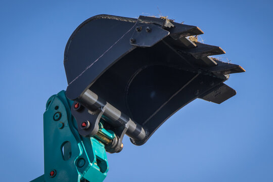 Shovel of excavator or bulldozer on sky background. Part of industrial machinery. Technology