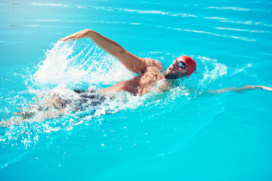 Training, backstroke and man in swimming pool for exercise, fitness or aquatic practice for health. Male person, swimmer style and workout for water sports, cardio conditioning and summer wellness
