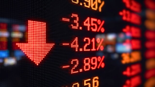 Digital stock market display showing falling percentages and downward arrow indicating financial crash and economic decline