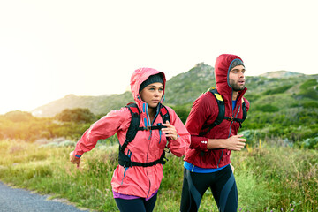 Fototapeta premium Fitness, couple and running in countryside for health, training or practice together for wellness. Man, woman and runner jog in nature, workout and cardio conditioning with exercise partner in winter