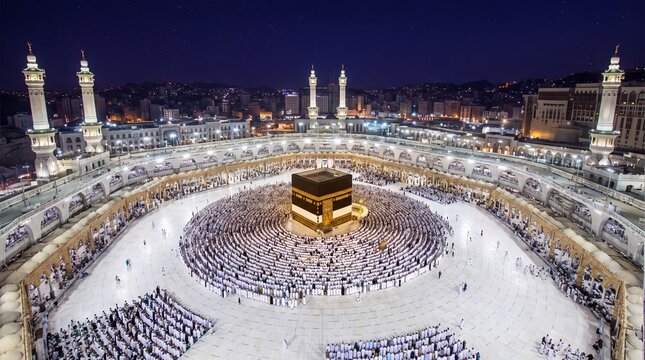 Aerial view of the Kaaba in Mecca with pilgrims praying during the night Hajj pilgrimage.