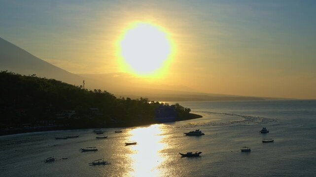 Golden Sunrise Over Amed Coastline with Fishing Boats