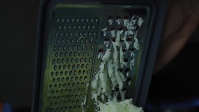 Cooking shakshuka, pouring tomatoes in a pan, and grating cheese. Homemade meal preparation, culinary recipe, and kitchen cooking process concept.