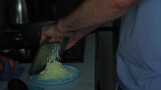 Cooking shakshuka, pouring tomatoes in a pan, and grating cheese. Homemade meal preparation, culinary recipe, and kitchen cooking process concept.