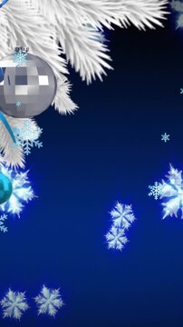 Animation of snowflakes floating over hanging bauble decorations on a branch against blue background