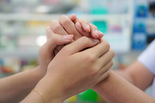 Community Pharmacist Holding Customer Hands, Compassionate Care and Reassurance
