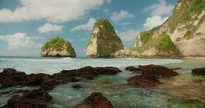 Clear water filling rocky crevices on a secluded shoreline Diamond Beach in Nusa Penida