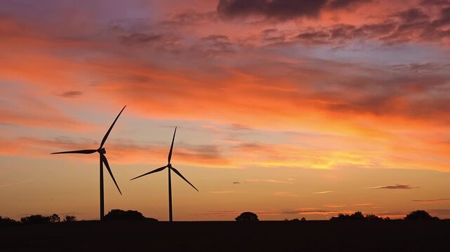 Vibrant Orange Sunset Timelapse Over Rural Landscape with Wind Turbines