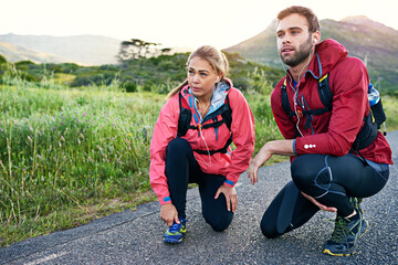 Fototapeta premium Fitness, road and thinking with couple in nature together for activity, bonding or cardio training. Exercise, relationship and vision with runner people outdoor on mountain path for start of workout