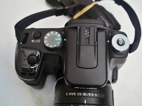 Sony DSLR camera on white background showing dial