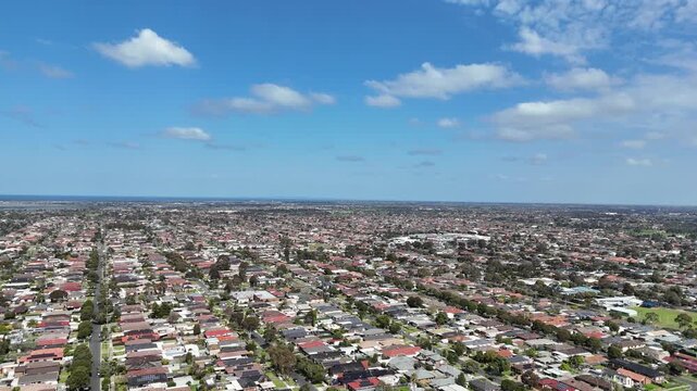 Extensive suburban residential housing grids and straight street layouts across Altona Meadows. Aerial view of houses in neighborhood in Melbourne, Victoria, Australia.
