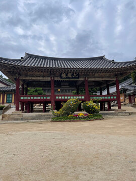 Ornate wooden gate pavilion with a tiled roof and colorful dancheong painting stands above a gravel courtyard in Yeoju, South Korea
