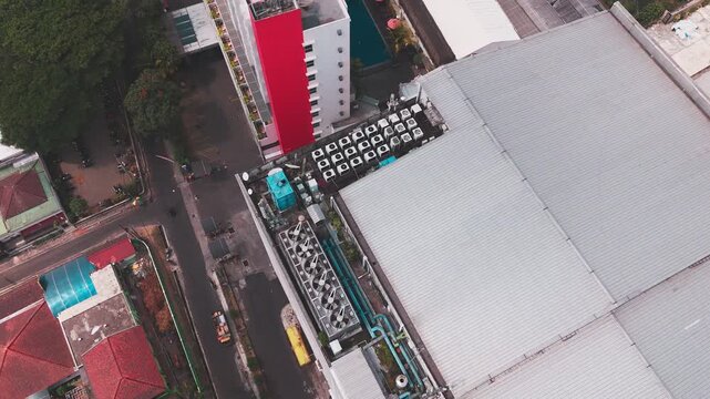 Aerial view of data center rooftop equipped with heavy-duty cooling units, industrial ventilation fans, condenser systems, and pipes for temperature control. Ideal for commercial technology, industria