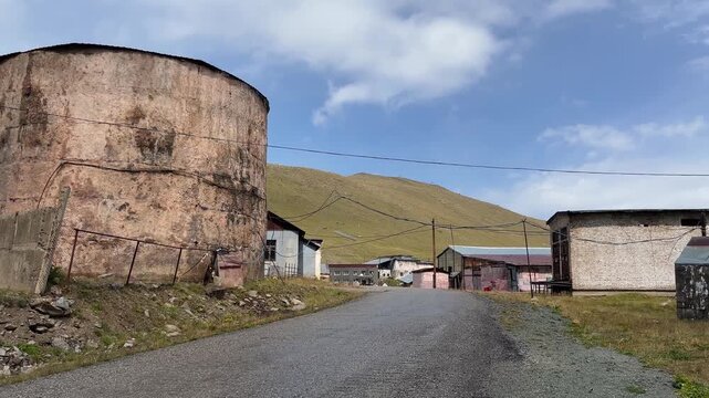 An old cosmic ray research station in the mountains near Almaty, Kazakhstan. Soviet-era buildings and a large water tank