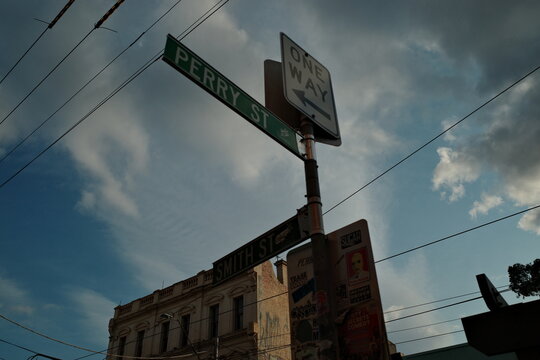street sign perry street smith street urban intersection with one way signage decorative architecture and cityscape perspective downtown view
