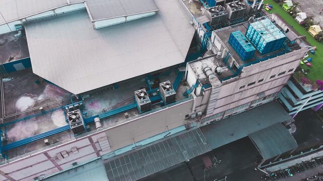 Aerial view of data center rooftop equipped with heavy-duty cooling units, industrial ventilation fans, condenser systems, and pipes for temperature control. Ideal for commercial technology, industria