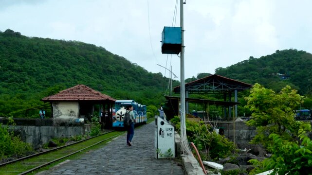 28 August 2026- Elephanta Island, Maharashtra, India: Tourist transport in the form of a toy train leaves the Elephanta Caves area during the monsoon season.
