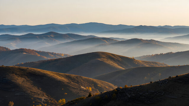 Layered mountain ranges fading into morning mist