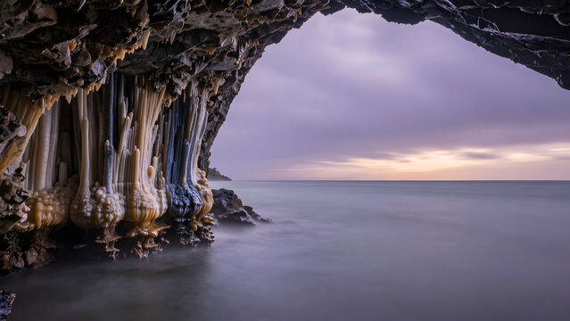 Cave formations and ocean view at twilight