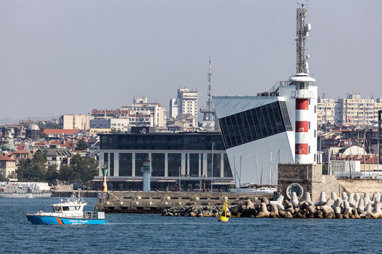 Police boat patrolling in front of the port of a city

