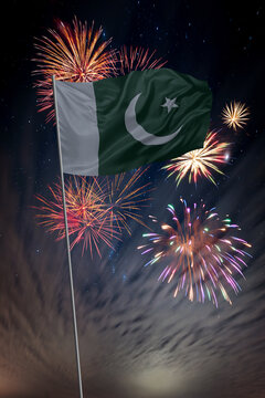 Waving National flag of Pakistan and holiday fireworks in night sky