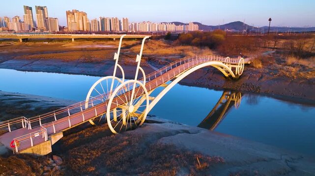 Aerial drone 4K view of the unique Bicycle Bridge (Misaeng Bridge) over muddy tidal flats in Sorae Wetland, South Korea

