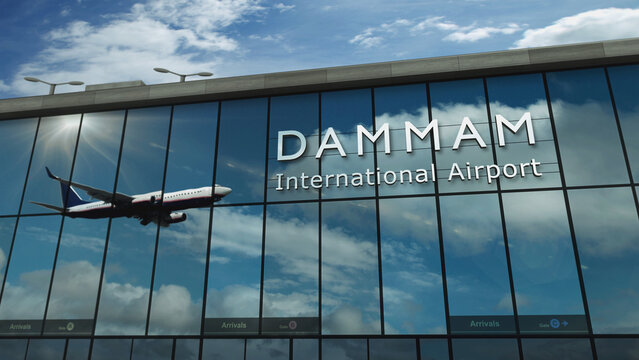 Airplane landing at Dammam Saudi Arabia airport mirrored in terminal