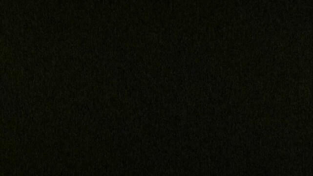 Textured black background animation shifts with subtle noise grain. Minimalist dark aesthetic copy space defines the textured background. Cinematic monochrome depth forms this textured background.