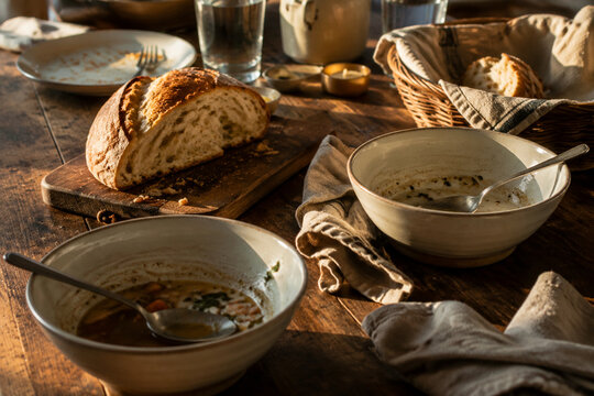 Dinner table with soup bowls and bread remnants, family meal and togetherness concept