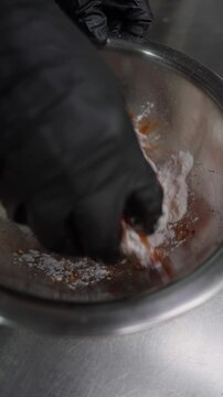 Chef Coating Chicken Strips in Cornstarch Flour by Hand - Vertical Video